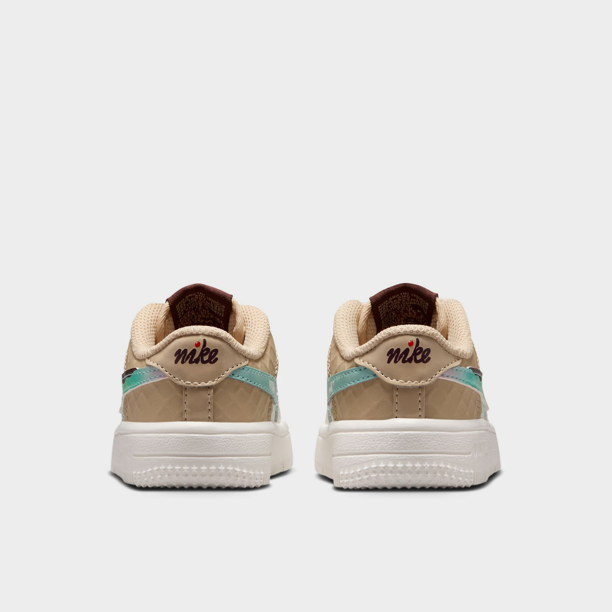 Nike Air Force 1 TD. Rear view of sail, multicolour and sesame toddler sneakers with beige heel panels, multicolour accents and white soles.