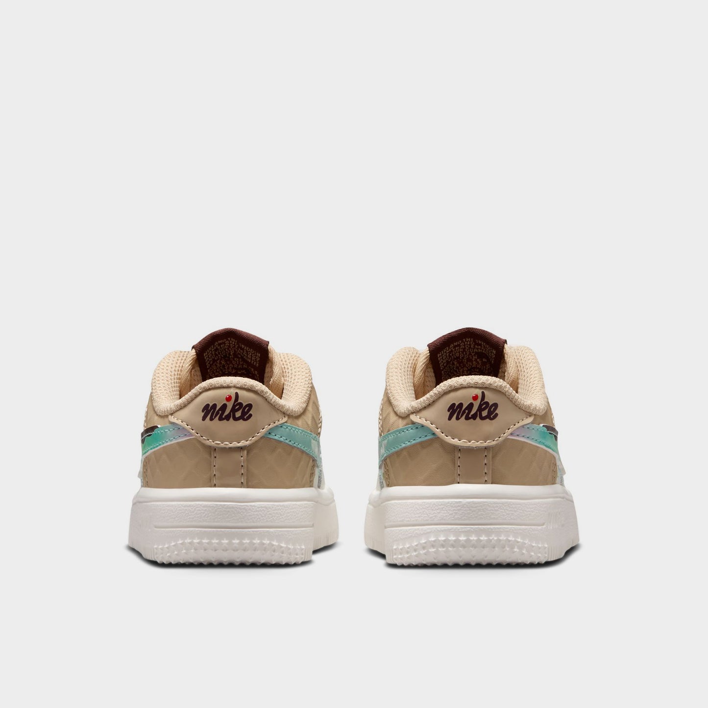 Nike Air Force 1 TD. Rear view of sail, multicolour and sesame toddler sneakers with beige heel panels, multicolour accents and white soles.
