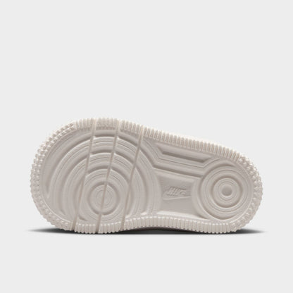 Nike Air Force 1 TD. Bottom view of sail toddler sneaker showing circular forefoot tread and grooved outsole pattern.