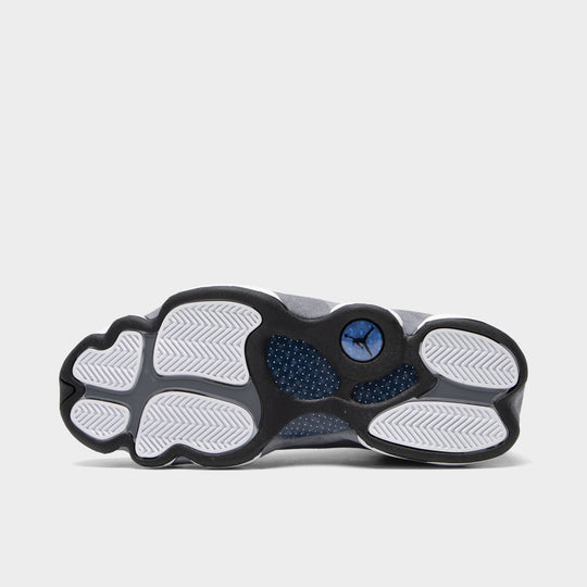 Jordan 13 Retro. Bottom view of navy and university blue basketball sneaker showing white, grey and navy outsole pods with blue centre detail.