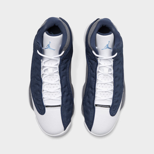 Jordan 13 Retro. Top view of navy and university blue basketball sneakers showing white laces, padded tongues and navy uppers.
