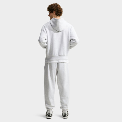 Nike Solo Fleece Full-Zip Hoodie. Full-length back view displaying birch heather fleece hoodie paired with matching grey sweatpants and dark shoes. 