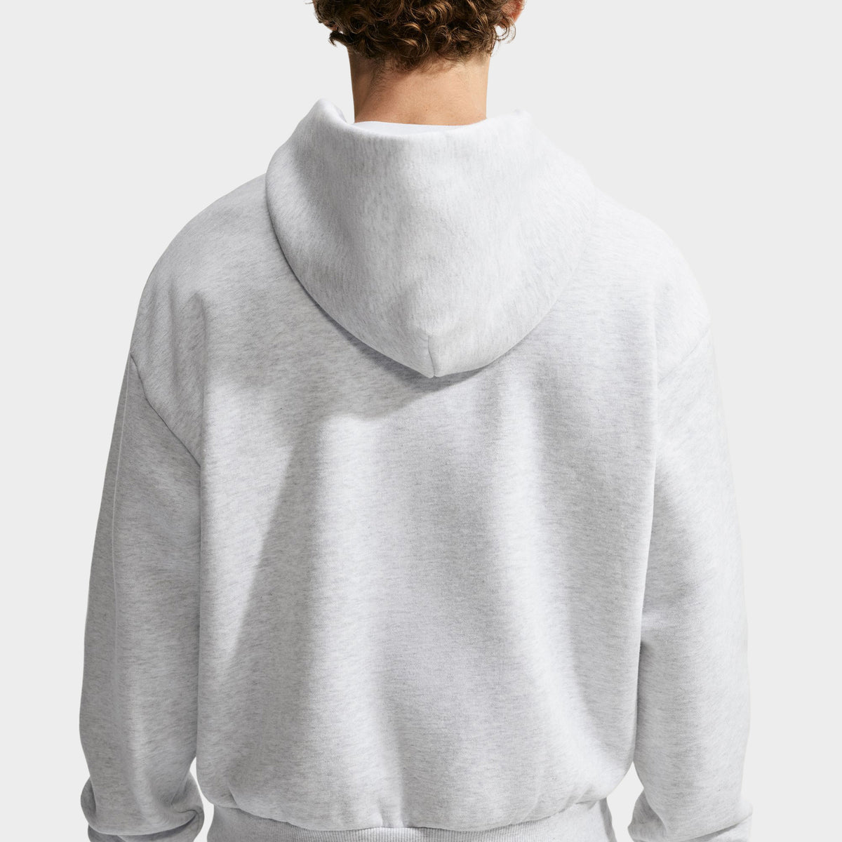 Nike Solo Fleece Full-Zip Hoodie. Plain back view displaying birch heather grey fleece construction, relaxed fit, dropped shoulders, and double-lined hood. 
