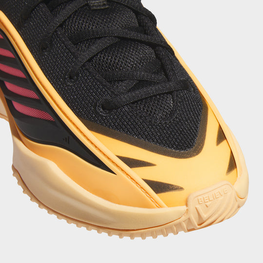 adidas Juniors' Believe That 1. Close-up of acid orange and core black junior basketball shoe showing black laces, layered upper and orange side detailing.