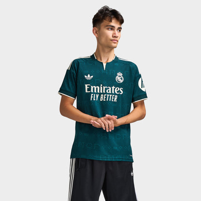 adidas Real Madrid Away Jersey. Front view of model wearing aurora ivy soccer jersey with white adidas logo, Real Madrid crest and Emirates Fly Better sponsor graphic.