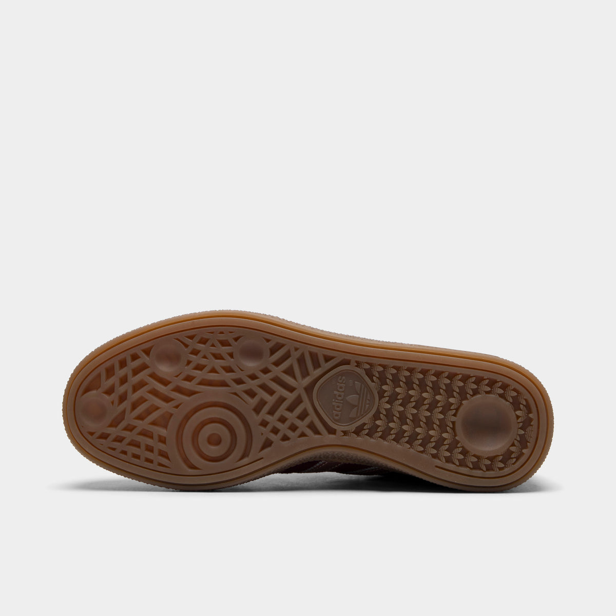 adidas Women's Handball Spezial. Bottom view of single shoe displaying full gum rubber outsole with traditional Handball Spezial indoor traction pattern and center adidas logo. 