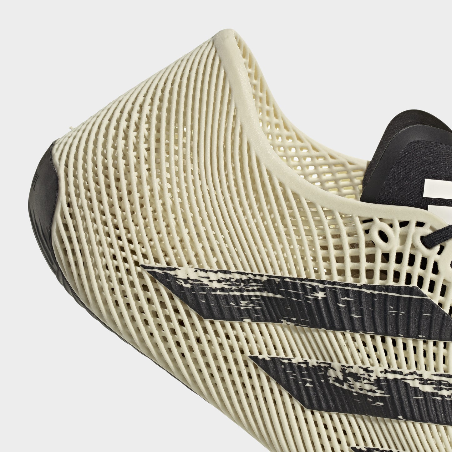 adidas Climacool Laced. Close-up of off white and black sneaker showing woven toe construction, black graphic detailing and curved sole.