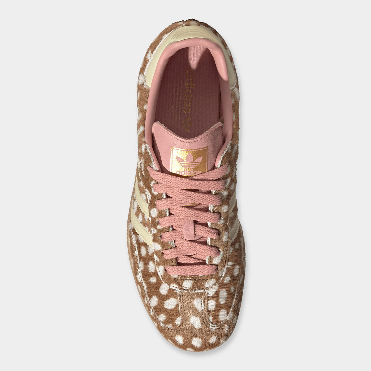 adidas Originals Women's Samba OG. Top-down overhead view of single shoe showcasing the brown desert spotted ponyhair upper, dusty pink laces, dusty pink leather tongue with gold foil Trefoil branding, and matching interior textile lining. 
