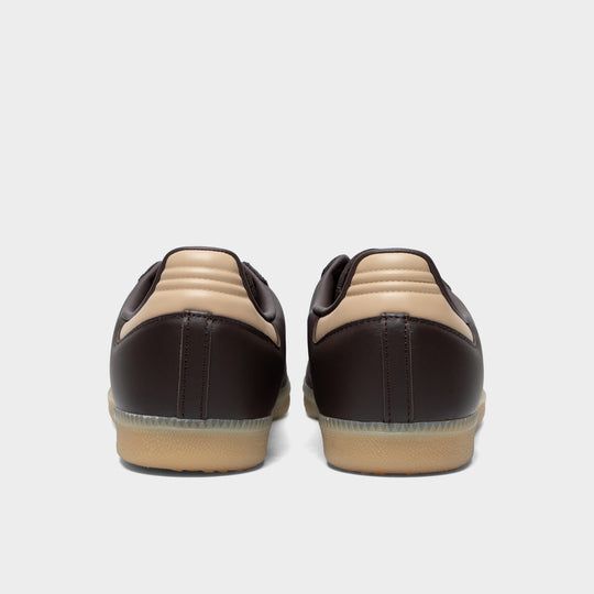 adidas Samba. Rear view of aurora coffee, core white and magic beige sneakers with dark heel panels and gum soles.