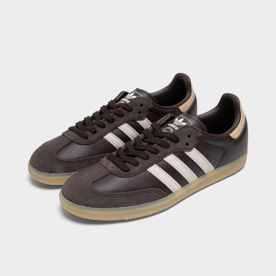 adidas Samba. Three-quarter view of aurora coffee, core white and magic beige sneakers with brown laces, white three stripes and gum soles.