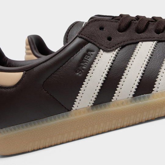 adidas Samba. Close-up of aurora coffee, core white and magic beige sneaker showing brown laces, white three stripes, layered panels and gold branding.