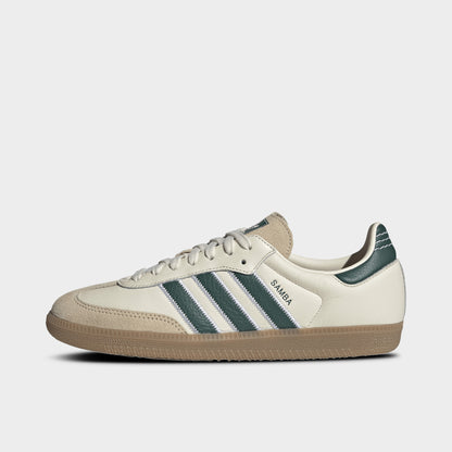 adidas Samba OG. Side view of cream, collegiate green and gum sneaker with green three stripes, suede toe overlay and gum sole.