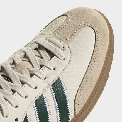adidas Samba OG. Close-up of cream, collegiate green and gum sneaker showing cream laces, suede toe overlay and green three stripes.