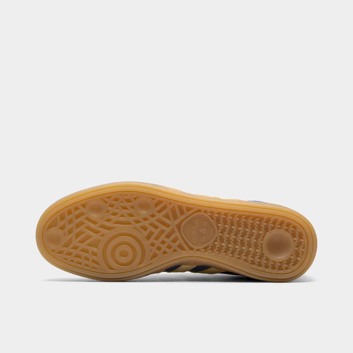 adidas Handball Spezial. Bottom view of dusky ink, easy yellow and gum sneaker showing brown gum outsole with circular forefoot tread.