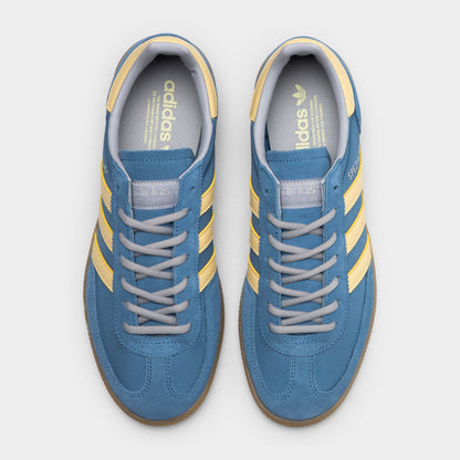 adidas Handball Spezial. Top view of dusky ink, easy yellow and gum sneakers showing blue laces, padded tongues and yellow collar details.