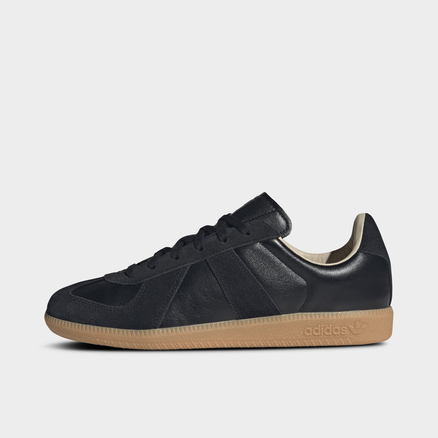 adidas BW Army. Side view of black and gum sneaker with tonal three stripes, stitched overlays and low-profile gum sole.
