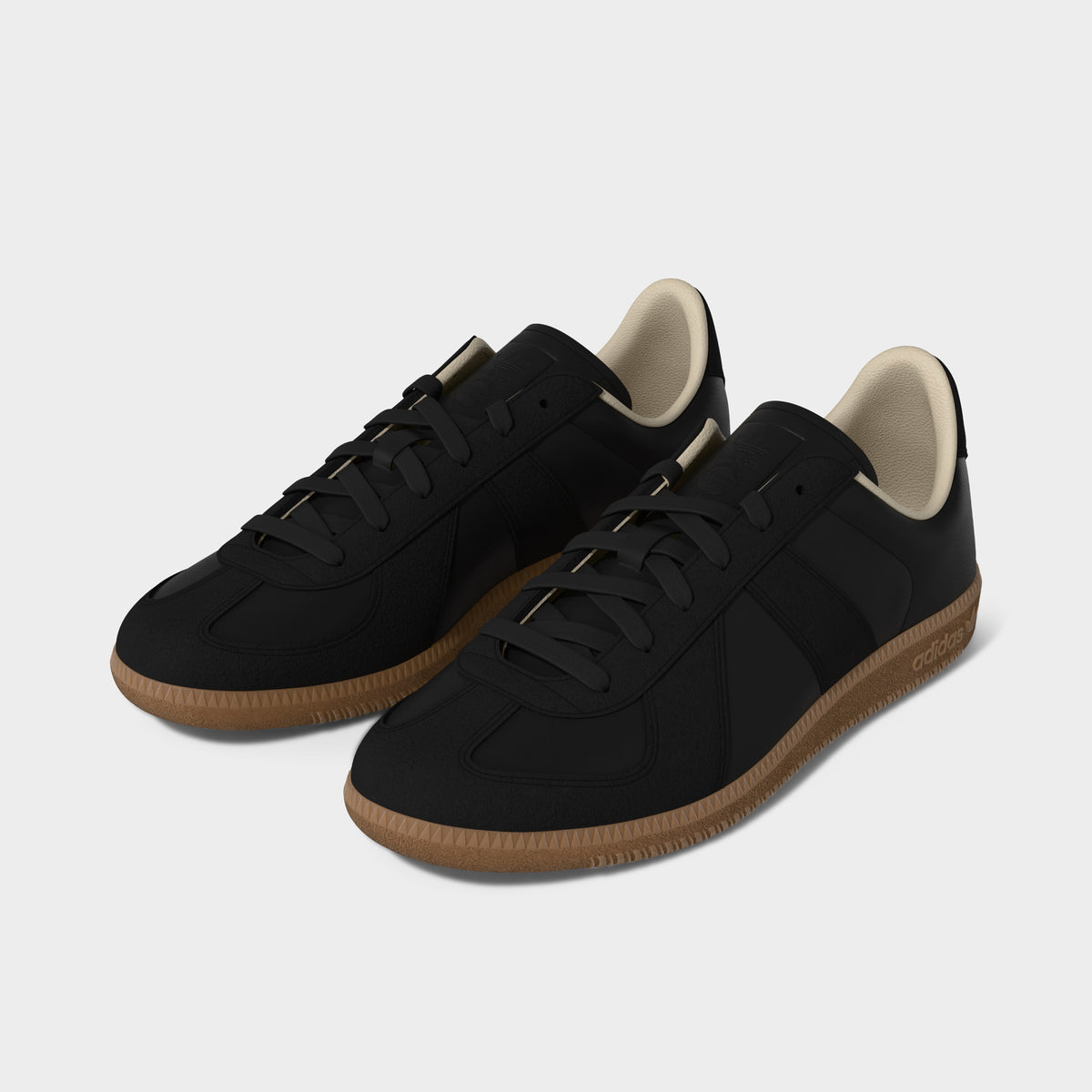 adidas BW Army. Three-quarter view of black and gum sneakers with black laces, tonal stripes and gum soles.