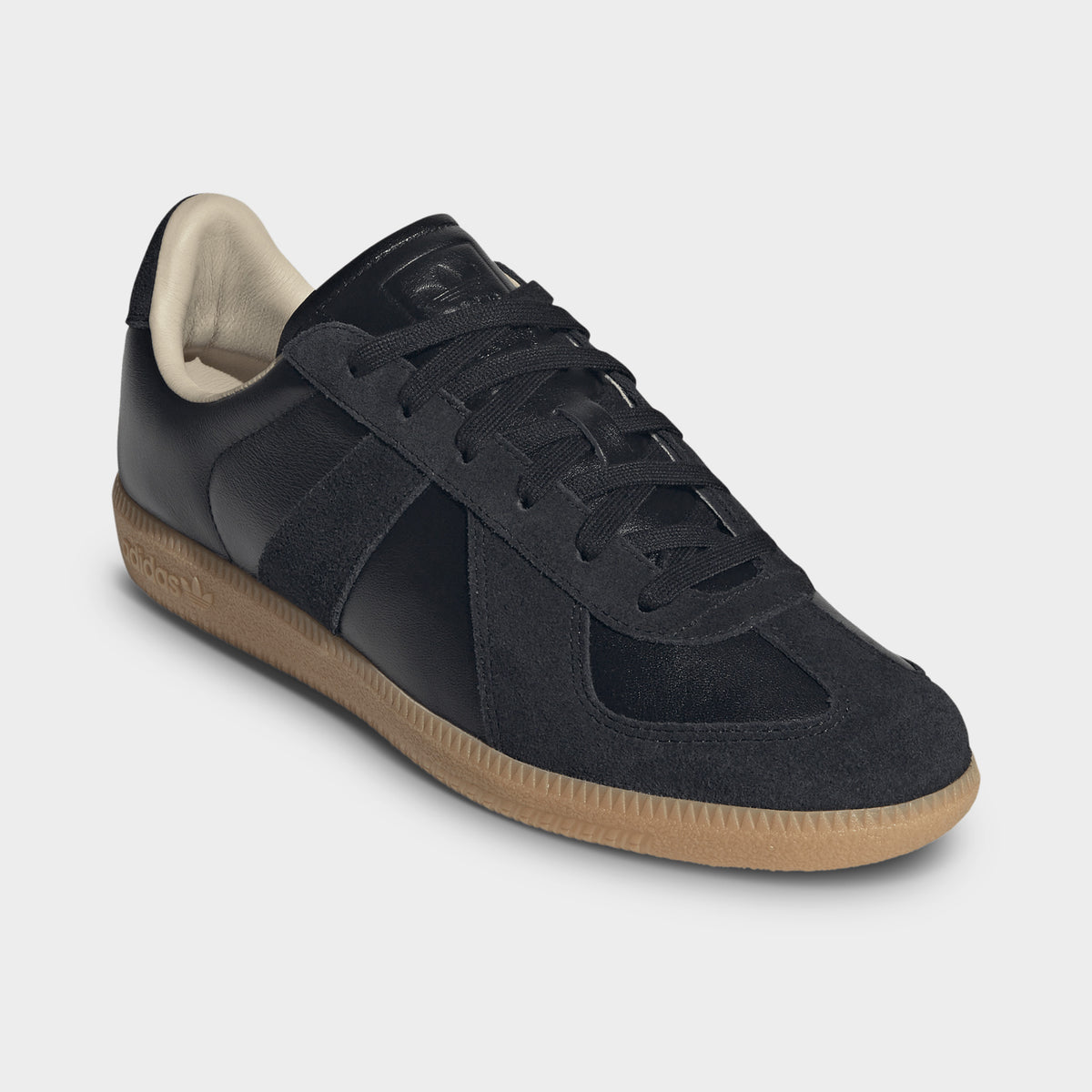 adidas BW Army. Three-quarter view of black and gum sneaker with tonal panels, black laces and gum sole.