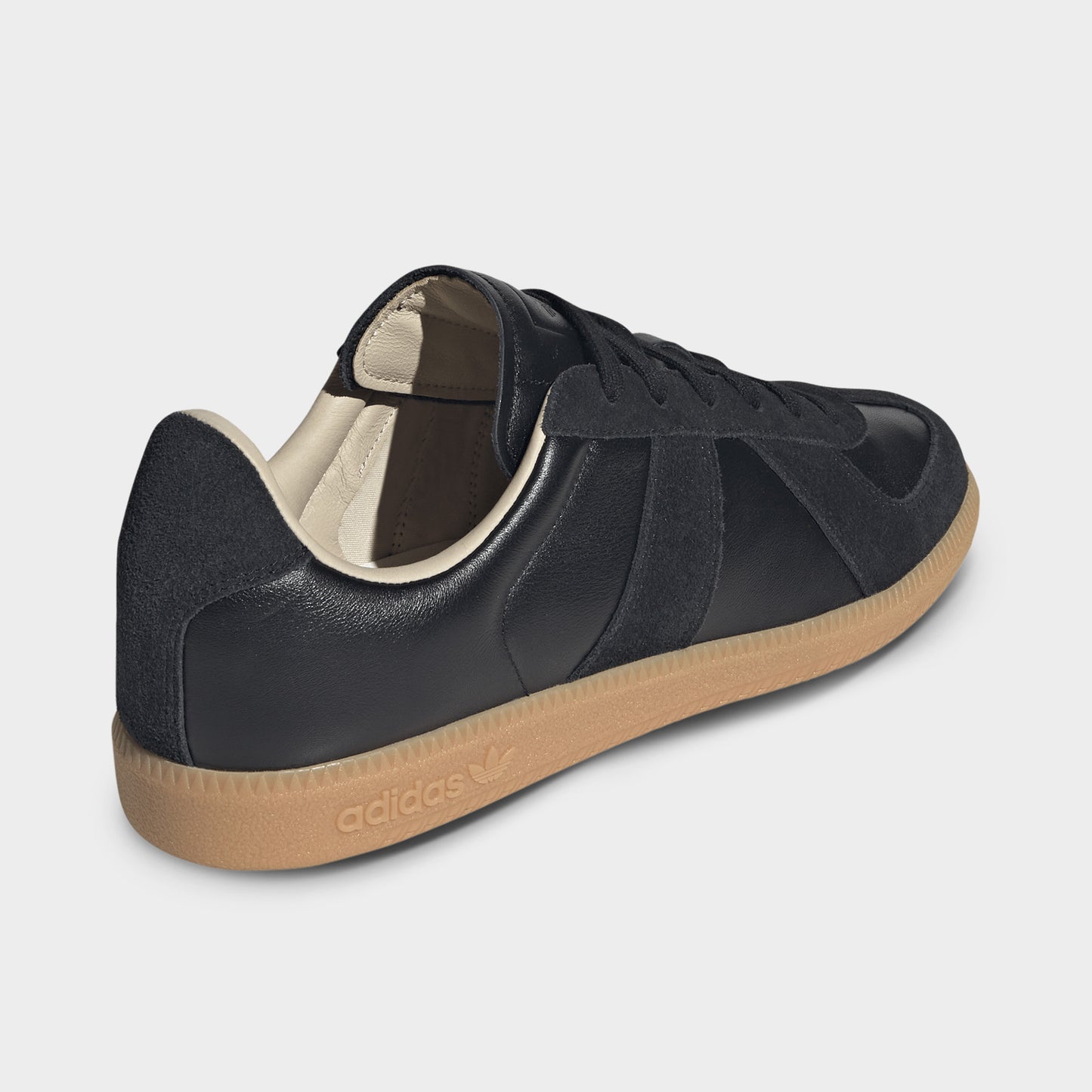 adidas BW Army. Rear three-quarter view of black and gum sneaker with black heel panel, padded collar and gum sole.
