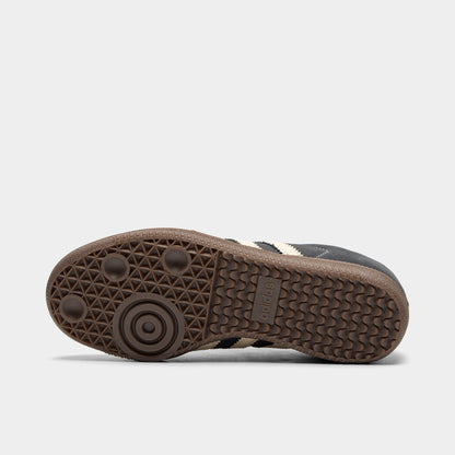 adidas Juniors' Samba OG. Bottom view of single shoe displaying full gum rubber outsole with classic Samba tread pattern, suction cup pivot points, and center adidas logo. 