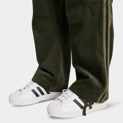 adidas Adicolor Cord Cargo Pants. Close-up of night cargo corduroy pants showing wide hems, ribbed texture and side cargo pocket.