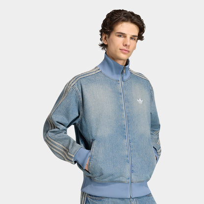 adidas Firebird Adicolor Track Top. Front view of model wearing worn blue denim track jacket with full-zip closure, high collar and white Trefoil chest logo.