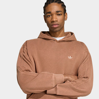 adidas Trefoil Essentials Washed Loose Hoodie. Close-up of preloved brown hoodie showing the hood, relaxed sleeves and white Trefoil chest logo.