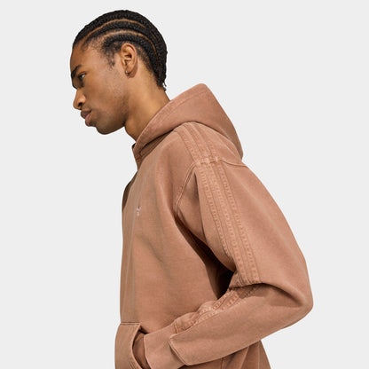 adidas Trefoil Essentials Washed Loose Hoodie. Side view of model wearing preloved brown hoodie with kangaroo pocket, ribbed hem and loose fit.