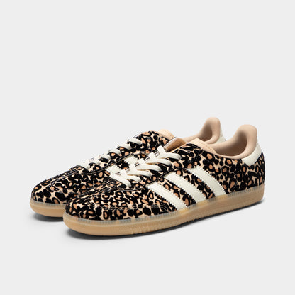adidas Juniors' Samba OG J. Three-quarter view of sand strata, ivory and gum junior sneakers with white laces, leopard-print uppers and gum soles.