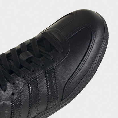 adidas Samba OG. Close-up of black sneaker showing black laces, tonal three stripes, stitched toe panel and textured upper.