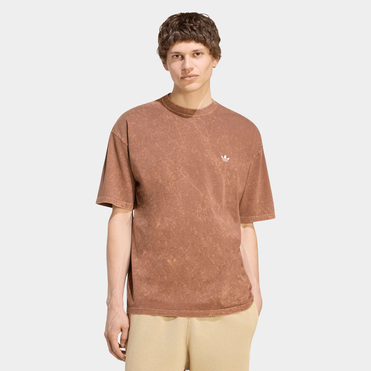adidas Trefoil Essential Washed Loose T-Shirt. Front view of model wearing preloved brown T-shirt with washed finish, loose fit and small white Trefoil chest logo.