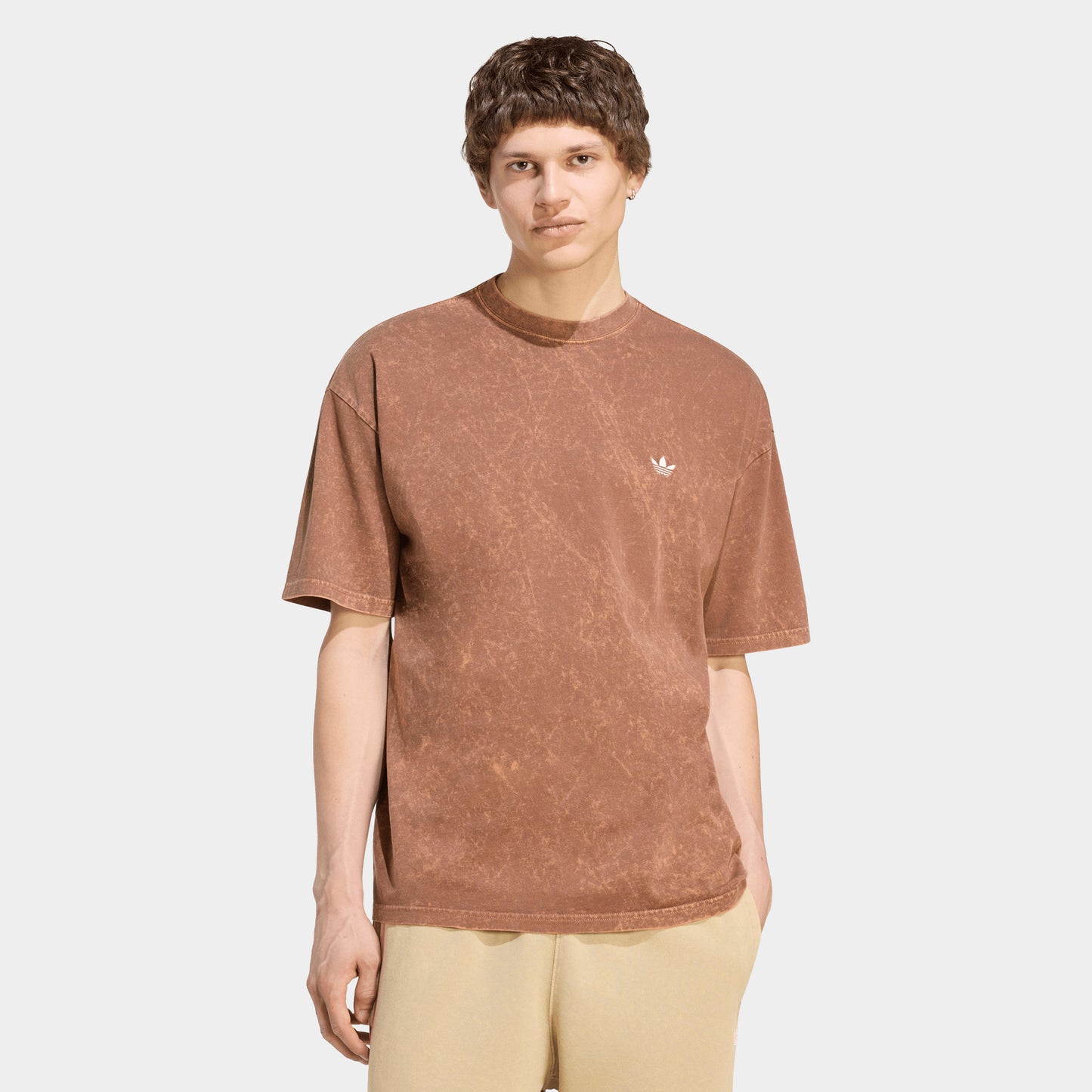 adidas Trefoil Essential Washed Loose T-Shirt. Front view of model wearing preloved brown T-shirt with washed finish, loose fit and small white Trefoil chest logo.