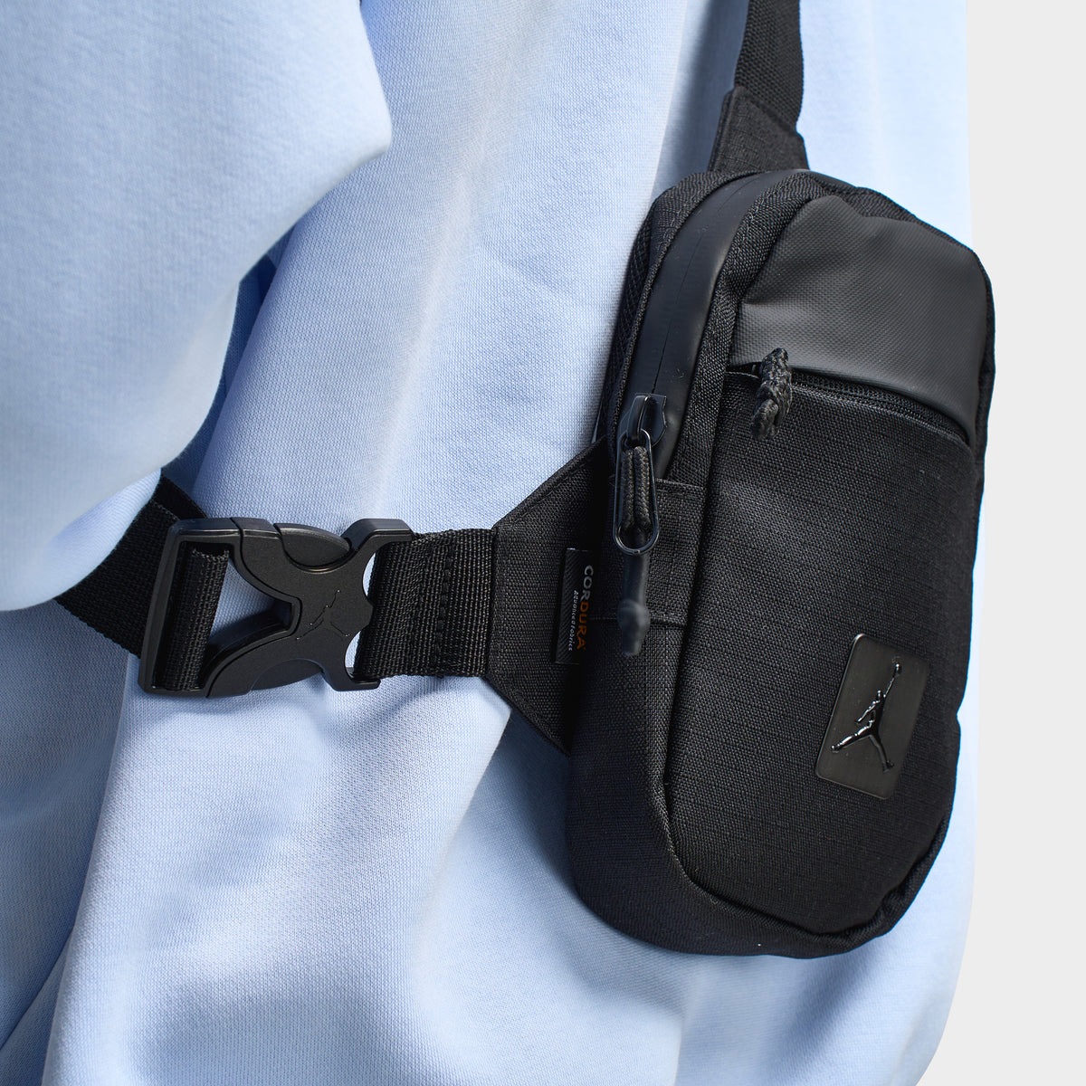 Jordan Franchise Hip Bag. Close-up of black hip bag showing adjustable buckle strap, compact profile and zippered compartment.