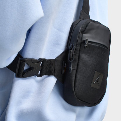 Jordan Franchise Hip Bag. Close-up of black hip bag showing adjustable buckle strap, compact profile and zippered compartment.