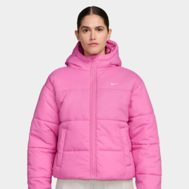 Woman wears Nike Women's Sportswear Classic Puffer Therma-FIT Loose Hooded Jacket "Playful Pink / White". Shop Women's Clothing now.