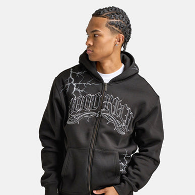 Man wears Hoodrich Dark Oversized Full-Zip Hoodie "Black". Shop Men's Clothing now