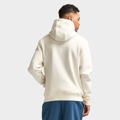 Sonneti London Hoodie 2.0. Back three-quarter view of model wearing egret hoodie with raised hood and relaxed silhouette.