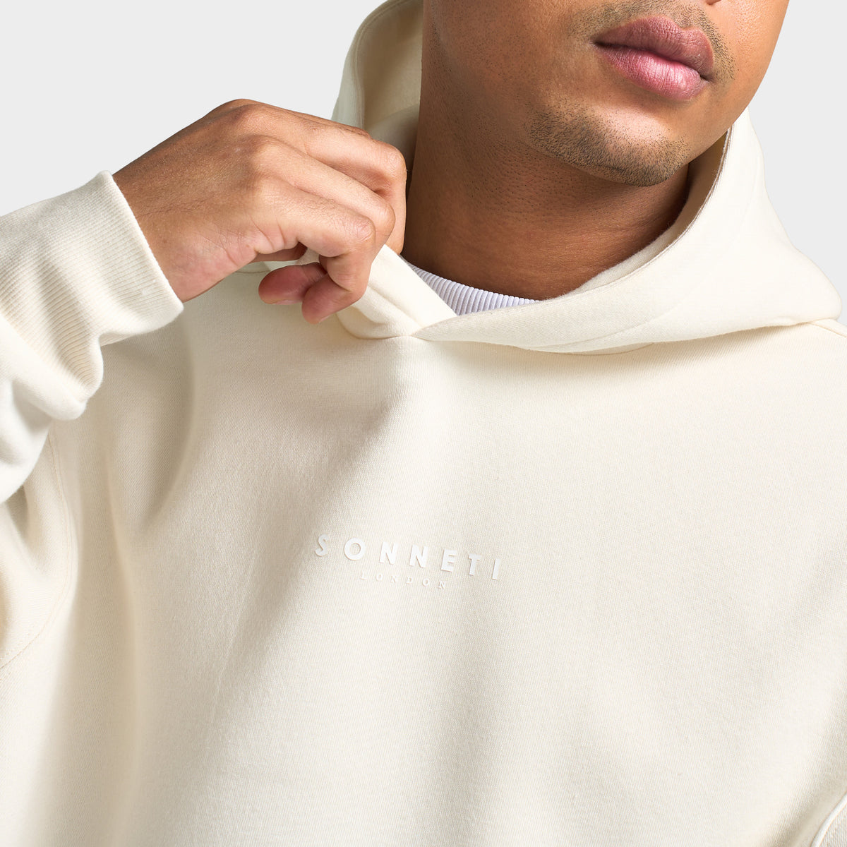 Sonneti London Hoodie 2.0. Close-up of egret hoodie showing the hood, neckline and smooth fabric finish.