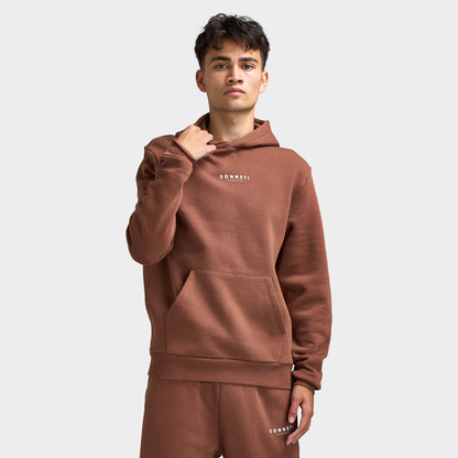 Sonneti London Hoodie 2.0. Front view of model wearing cocoa brown hoodie with kangaroo pocket, drawstring hood and small white Sonneti chest branding.