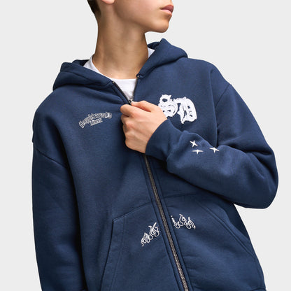 Supply & Demand Juniors' Scape Hoodie. Close-up of washed navy hoodie showing full-zip closure, hood, white chest graphic and drawcord detail.