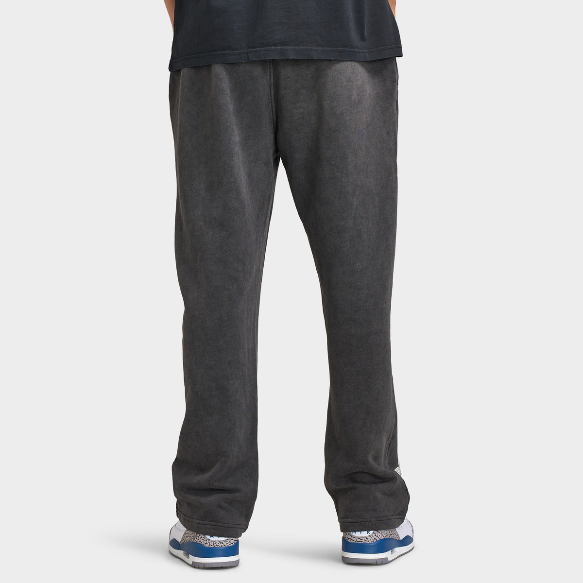 Supply & Demand Murphy Oversized Pants. Back view of model wearing black oversized pants with wide legs, relaxed fit and plain rear panels.