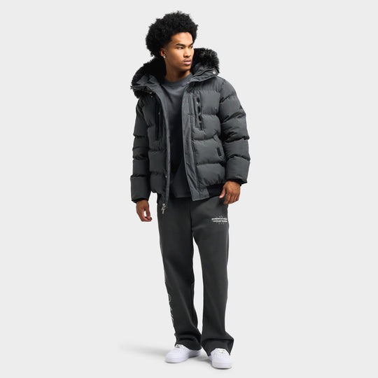 Supply & Demand Croft S Parka. Full-length front view of model wearing volcanic ash grey faux-fur parka paired with grey sweatpants and white sneakers. 
