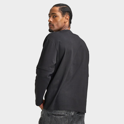 Supply & Demand Global Longsleeve Tee. Back three-quarter view of model wearing black long-sleeve T-shirt with plain back and relaxed fit.