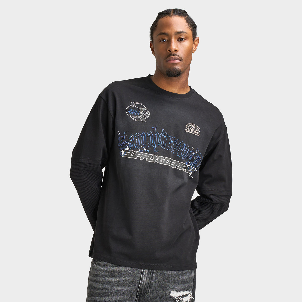 Supply & Demand Global Longsleeve Tee. Front view of model wearing black long-sleeve T-shirt with large blue and grey graphic across the chest.