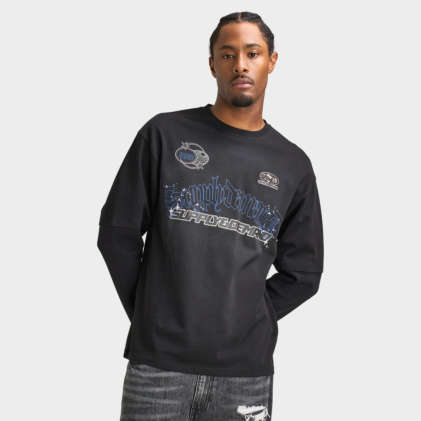 Supply & Demand Global Longsleeve Tee. Front view of model wearing black long-sleeve T-shirt with large blue and grey graphic across the chest.