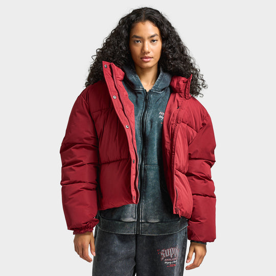 Supply & Demand Women's Macy Jacket. Front view of model wearing pomegranate puffer jacket with high collar, front zip closure and relaxed fit.