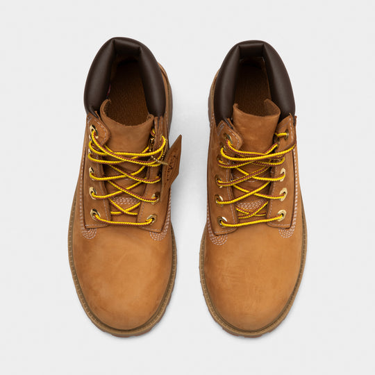 Timberland Juniors' 6" Premium Lace Up Waterproof Boot. Top view of wheat junior boots showing yellow laces, padded black collars and rounded toe boxes.