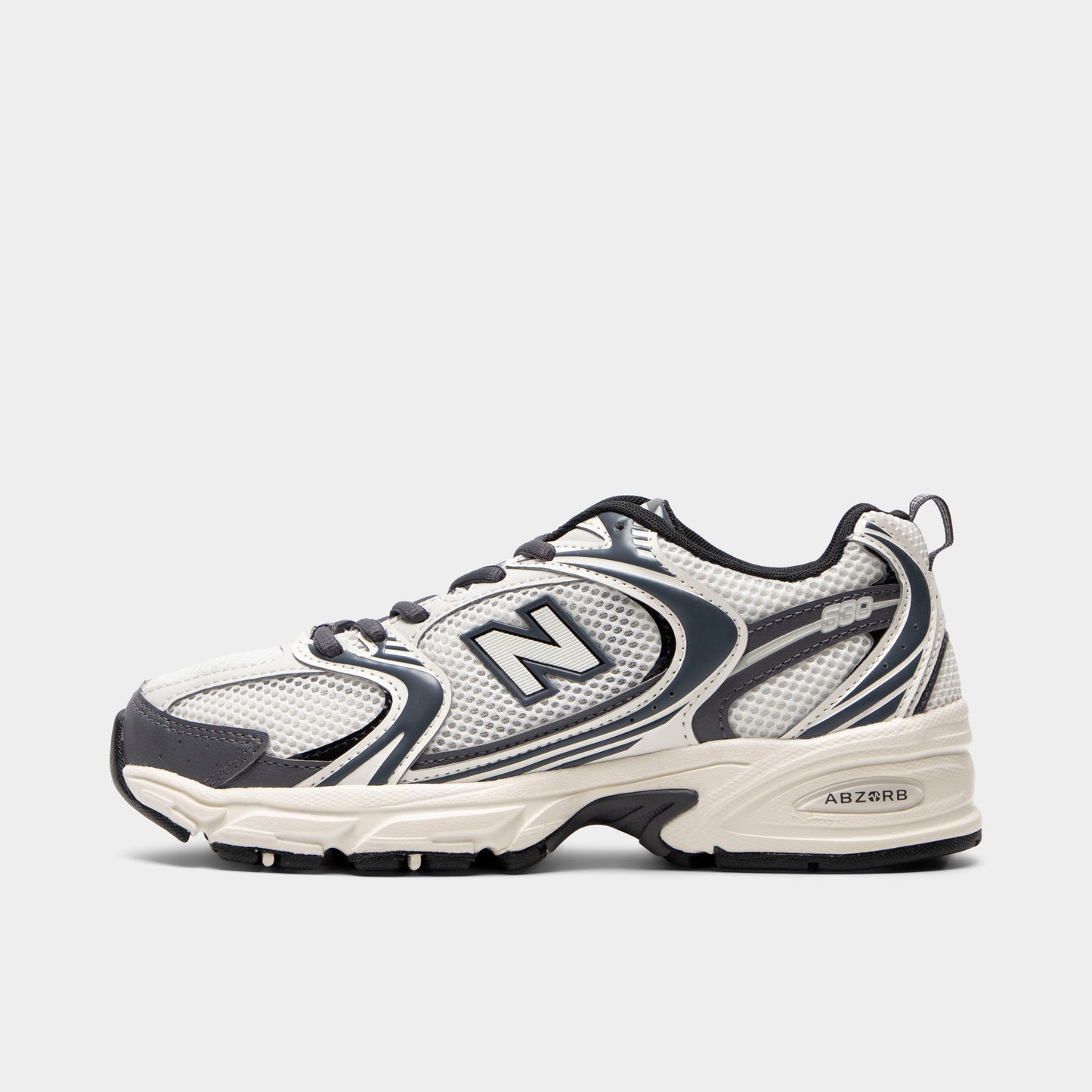 New Balance 530. Side view of sea salt and magnet sneaker with layered mesh panels, dark N logo and sculpted sole.