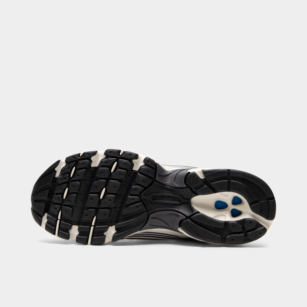 New Balance 530. Bottom view of sea salt and magnet sneaker showing black and cream segmented outsole with textured tread pattern.