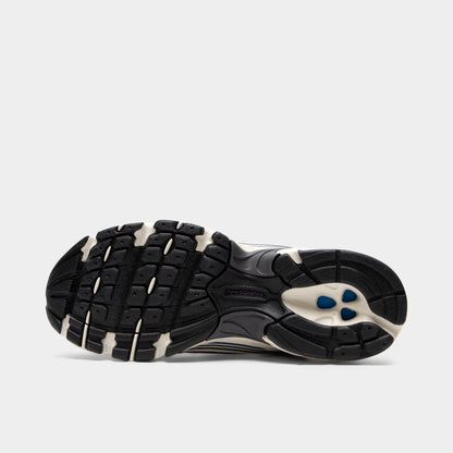 New Balance 530. Bottom view of sea salt and magnet sneaker showing black and cream segmented outsole with textured tread pattern.